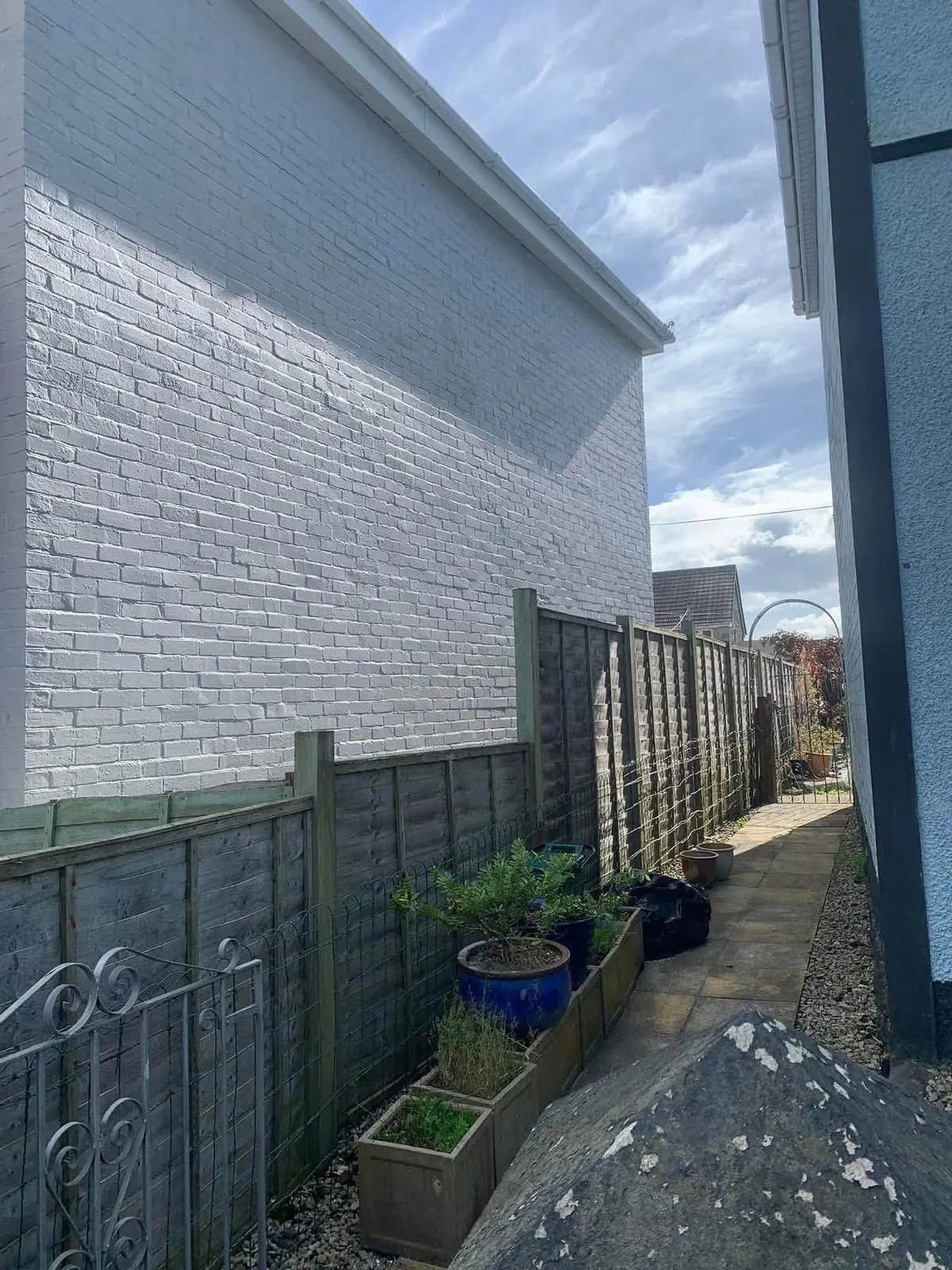 Freshly painted brick wall after preparation and masonry paint in Mousehole